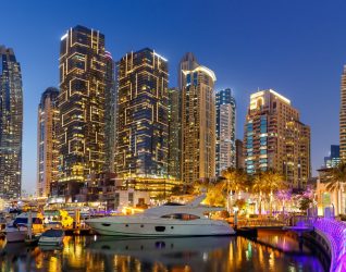 Dubai Marina and Harbour skyline architecture wealth luxury travel with yacht boat at night panorama in United Arab Emirates Dubai Marina and Harbour skyline architecture wealth luxury travel with yacht boat at night panorama in United Arab Emirates modern
